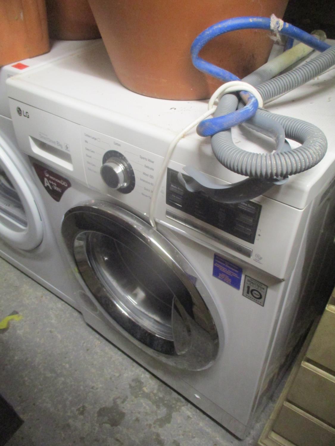 An LG Direct Drive washing machine 33 1/2"h x 23 1/4"w