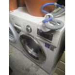 An LG Direct Drive washing machine 33 1/2"h x 23 1/4"w