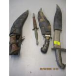 A WW2 commando fighting knife, possibly etched Wilkinson Sword London, together with three kukri