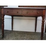 A Regency mahogany writing table with a gilt, tooled, green leather top, over two frieze drawers, on
