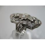 An Art Deco white gold coloured dress ring set with three diamonds stamped 18 K, size L, total