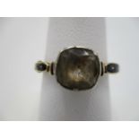 A yellow gold coloured George III mourning ring set with a cushion shaped stone, possibly a white