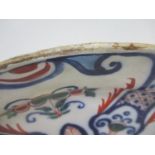 An 18th century Dutch Delft dish decorated with flowers, scrolls, dots and leaves in green, blue and