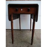 A Regency string inlaid mahogany Pembroke table with twin fall flaps, over an end drawer with