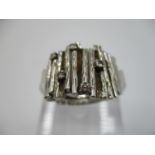 A 9ct white gold dress ring with bark pattern inset with five diamonds, size L, total weight 12.25g