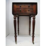 An early 19th century walnut work table with twin fall flaps over a compartmented drawer and another