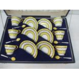 An Aynsley china tea set decorated in yellow and gilt and a matching set of six silver and enamelled