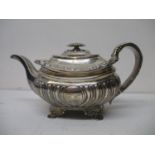 A George III silver teapot, makers mark rubbed, London 1817, of demi reeded and fluted form,