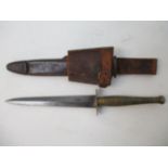 A British military dagger with a brass engine turned handle and a double edged blade, 11 1/4"l in