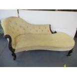 A Victorian rosewood framed chaise longue with scroll and floral carved ornament and part button