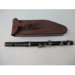 A military R Stark rosewood two section piccolo in a brown leather case