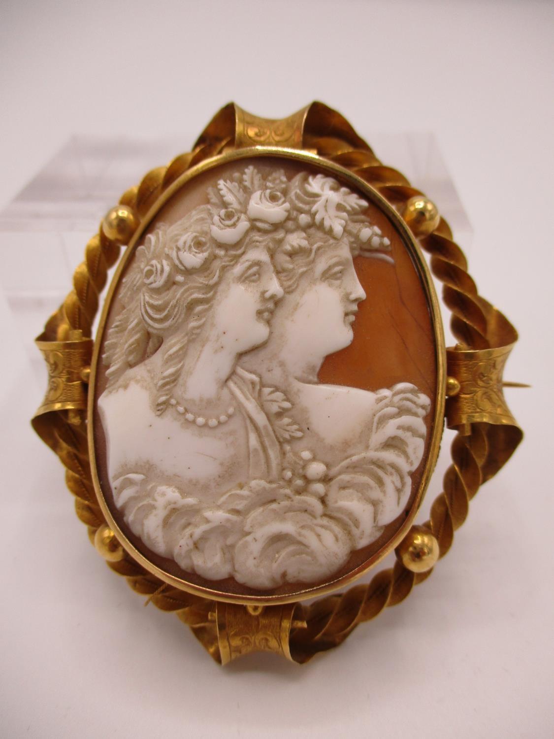 A Victorian yellow metal framed cameo brooch with oval shell cameo depicting two maidens with ornate - Image 2 of 12