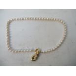 An Italian pearl necklace with a gold coloured metal clasp and heart shaped pendant stamped Italy