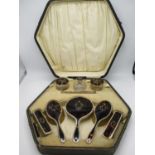 An early 20th century tortoiseshell and silver dressing table set with pique decoration, by