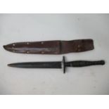 A British military blackened commando dagger with a metal ringed handle and double edged blade (