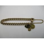 A 9ct yellow gold curb bracelet with a 9ct gold padlock, an 18ct gold St Christopher and a large