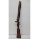 An early 19th century Indian Flintlock carbine with a 16 1/8" barrel, the lock-plate stamped with an
