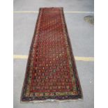 A North Persian runner with geometric boteh and vines on a black ground, 43" x 52"