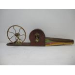 A Victorian stained pine and brass peat bellows with a spoked wheel, rounded box and tapering