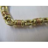 A gold coloured metal necklace with oval and ring links, stamped 750, 18 1/2"l, 36.6g and a matching