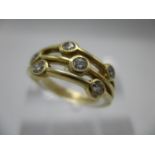 An 18ct yellow gold ring, the upper section fashioned as three bands, each set with two diamonds,