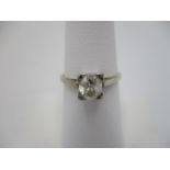 A gold and platinum coloured metal claw set diamond, solitaire ring, approximately 1 carat, size