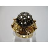 A 19th century gold coloured metal and diamond ring, the domed top set with eight old mine cut