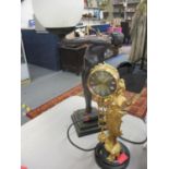 A late 20th century table lamp together with a gilt clock suspended from a gilt figure