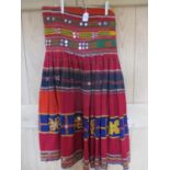 An early 20th century ethnic Banjara handmade mirror skirt, in red, blue orange and yellow,