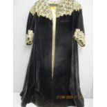 An early 20th century black velvet opera coat, label Switzer, Dublin, having a gold thread, lace and