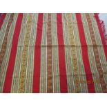 A mid to late 20th century Eastern throw in rich red and gold colours having a fringe