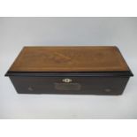 A Victorian walnut and marquetry lidded musical box decorated with weapons, a horn and flowers,