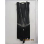 A 1920s black Charleston dress with diamante bead detail having a black fringe, measurements