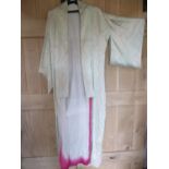 A 20th century pale green silk kimono with a cream lining having a fuchsia coloured edge,