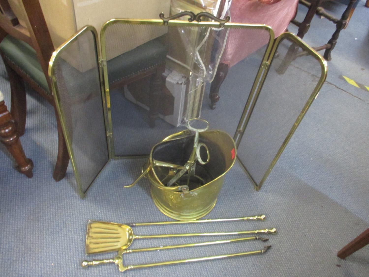 A selection of brass fireside items to include a coal bucket, screen and other items