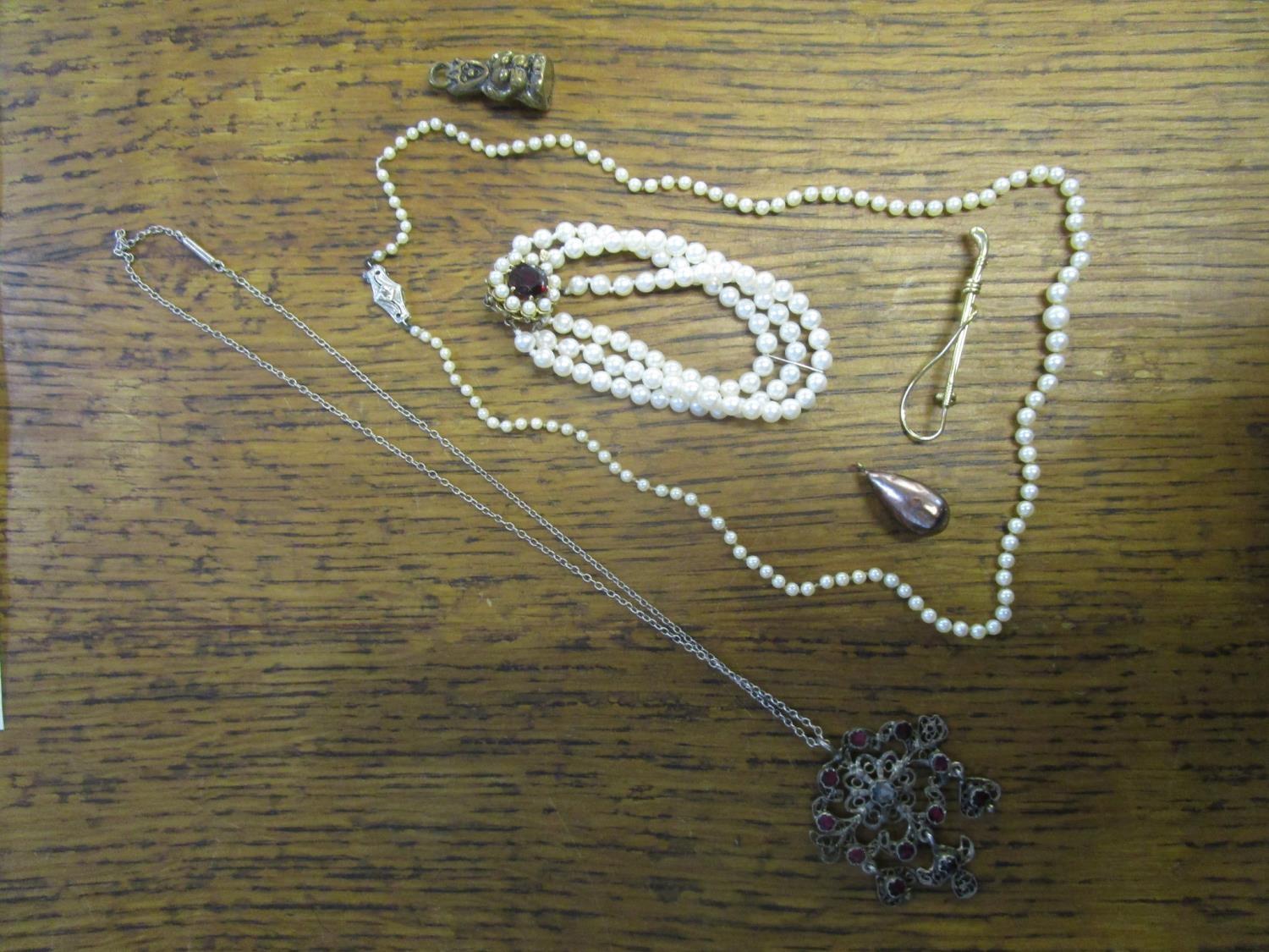 A selection of costume jewellery to include a triple strand pearl bracelet