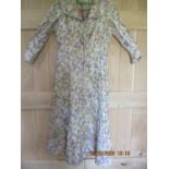 A 1940's Yun Chong of China, handmade, full length dress with front zip fastening, having a cream