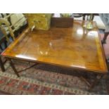 A modern yew wood coffee table having tapering fluted legs and cross framed support, 19" h x 42 1/