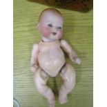 An early 20th century Armand Marseille Dream Baby bisque headed doll, blue sleeping eyes, showing