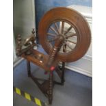 A 19th century spinning wheel having bobbin turned supports