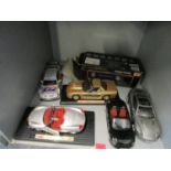 A group of diecast model display cars to include a Maisto Porsche Boxter and a Beanstalk Group Aston