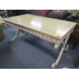 A modern painted coffee table having gilt highlights and cross framed supports, 18 3/4" H x 41 3/
