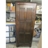 An Old Charm oak corner cabinet with two panelled doors
