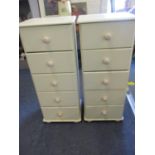 A pair of modern cream painted five drawer chests