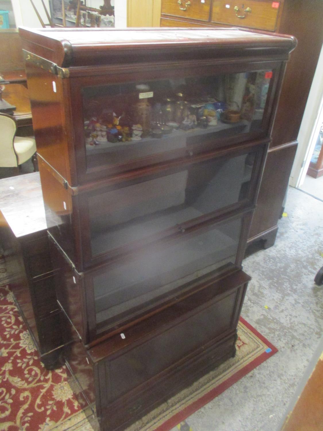 An early 20th century mahogany Globe Wernicke four tier bookcase with a drawer below 65 1/4" H x 34"