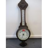 An early 20th century oak wall hanging barometer