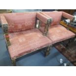 A pair of reproduction Empire style armchairs having carved mask and ring arms and H framed supports