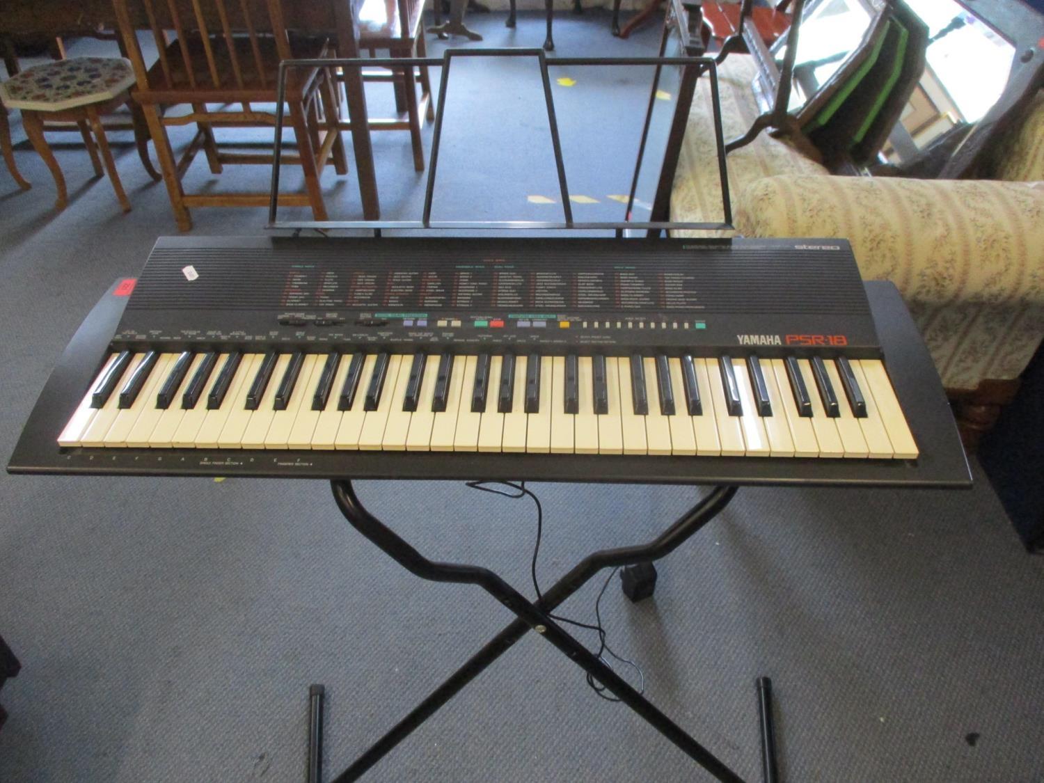 A late 20th century Yamaha keyboard and stand and two other keyboards