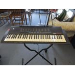 A late 20th century Yamaha keyboard and stand and two other keyboards