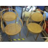 A pair of Brentwood armchairs with cane backs and seats